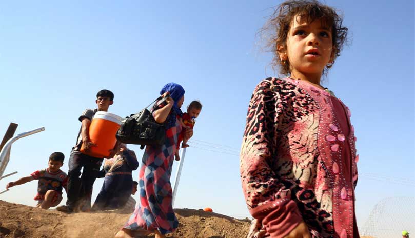 Christian families fleeing their centuries-old homes in Mosul, Iraq as a result of the violent persecution by ISIS (Photo by Reuters)